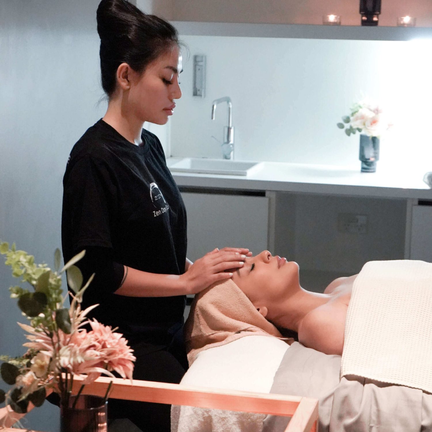 Zen Day Spa therapist performing a relaxing facial treatment